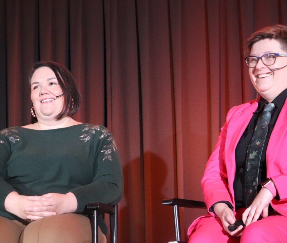 Jenn and Meggan smiling on stage