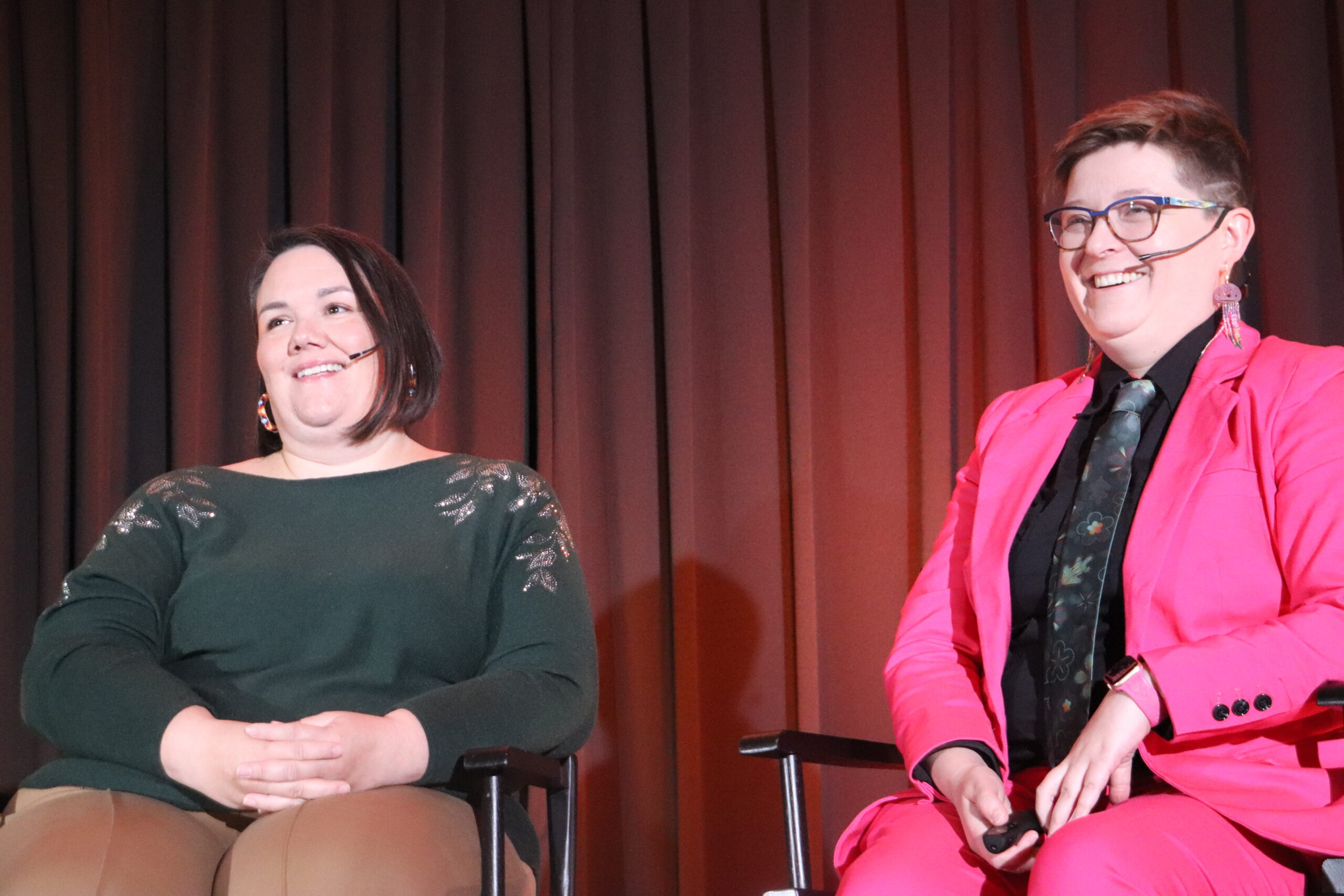 Jenn and Meggan smiling on stage